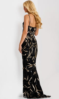A woman with long blonde hair wears the Jovani 48610 Long Prom Dress in black and gold with a leaf pattern and high-leg slit, standing against a plain white background facing away.