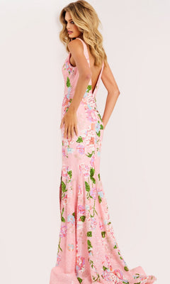A woman models the Jovani 48636 long prom dress, featuring a fitted bodice and flared skirt in pink floral style, against a plain light background.