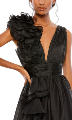 Woman in the Mac Duggal 48856 Ruffled Long Prom Ball Gown—a sleeveless black evening dress with a deep V-neck and ruffled accents on the shoulder and waist, perfect for special occasions.
