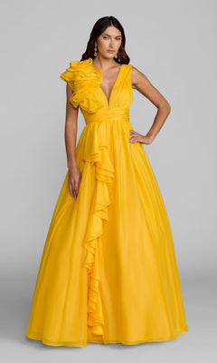 A woman stands against a light gray background wearing the Mac Duggal 48856 Ruffled Long Prom Ball Gown—a bright yellow, floor-length A-line dress with one-shoulder ruffles cascading down the front.