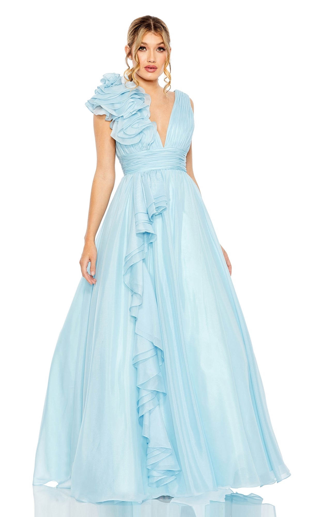 A woman stands against a plain white background wearing the Mac Duggal 48856 Ruffled Long Prom Ball Gown—a light blue, floor-length dress with ruffled details on one shoulder and down the front.