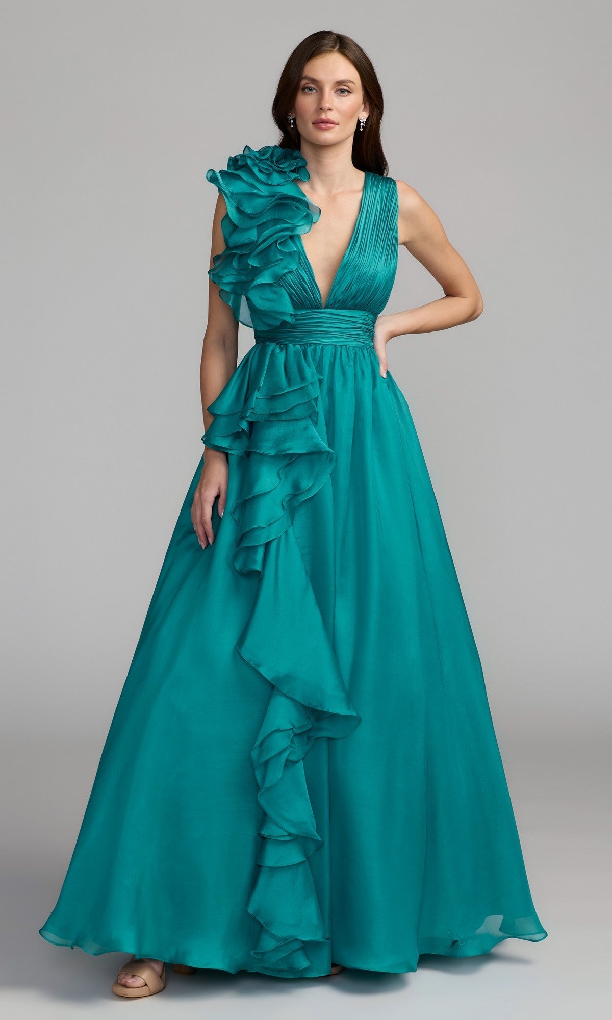 A woman models the Mac Duggal 48856 Ruffled Long Prom Ball Gown, a sleeveless teal evening dress featuring ruffled detailing on one shoulder and down the front, posed against a plain background.