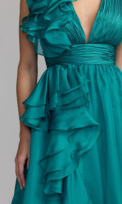 A close-up of the Mac Duggal 48856 Ruffled Long Prom Ball Gown, a sleeveless teal A-line dress with ruffled fabric details and a deep V-neckline.