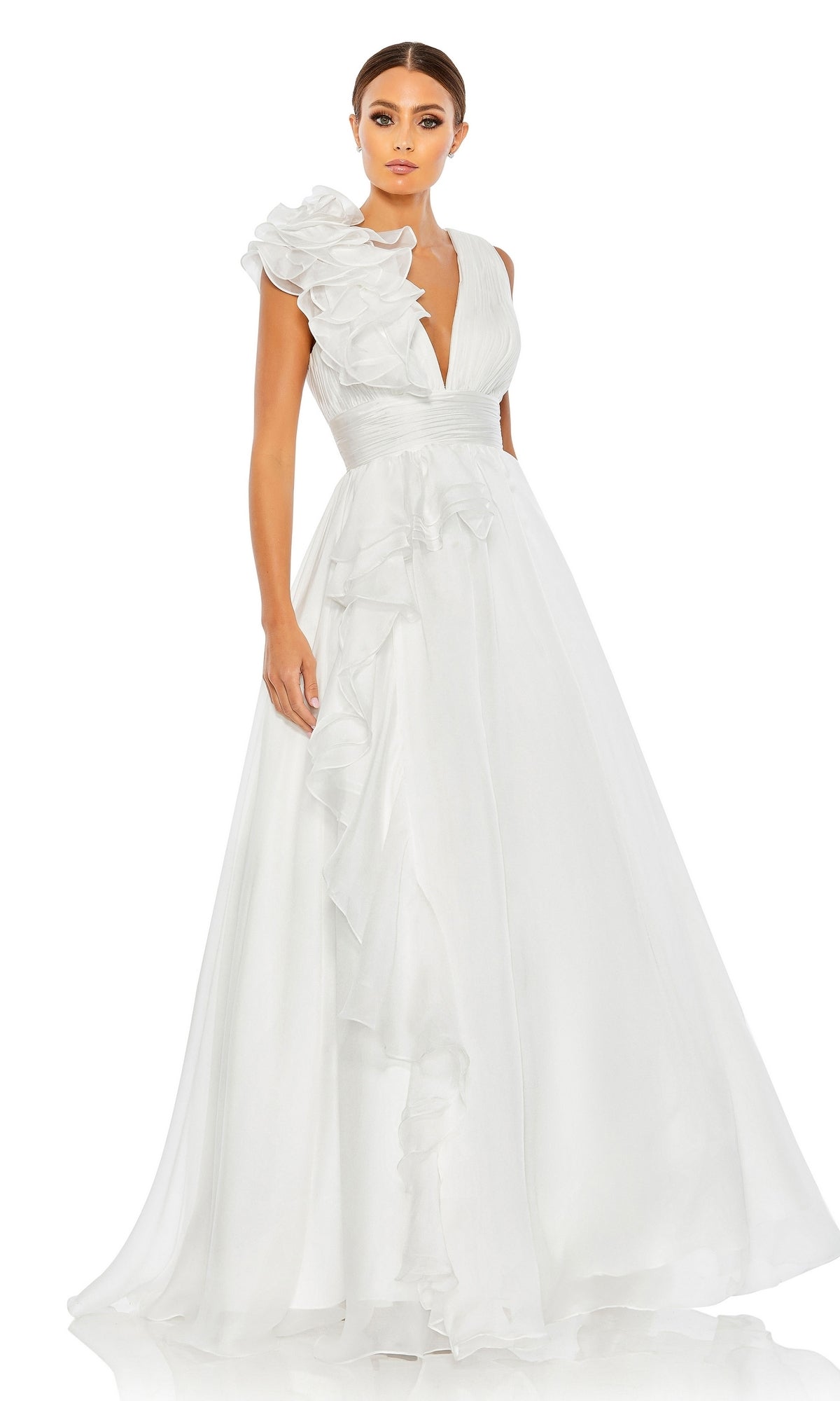 A woman wears the Mac Duggal 48856 Ruffled Long Prom Ball Gown, a floor-length white dress with a deep V-neck and ruffled shoulder detail, standing against a plain white background.