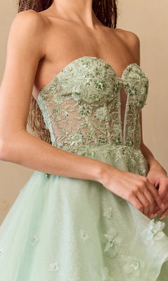 Light green strapless dress with floral lace details on a neutral background