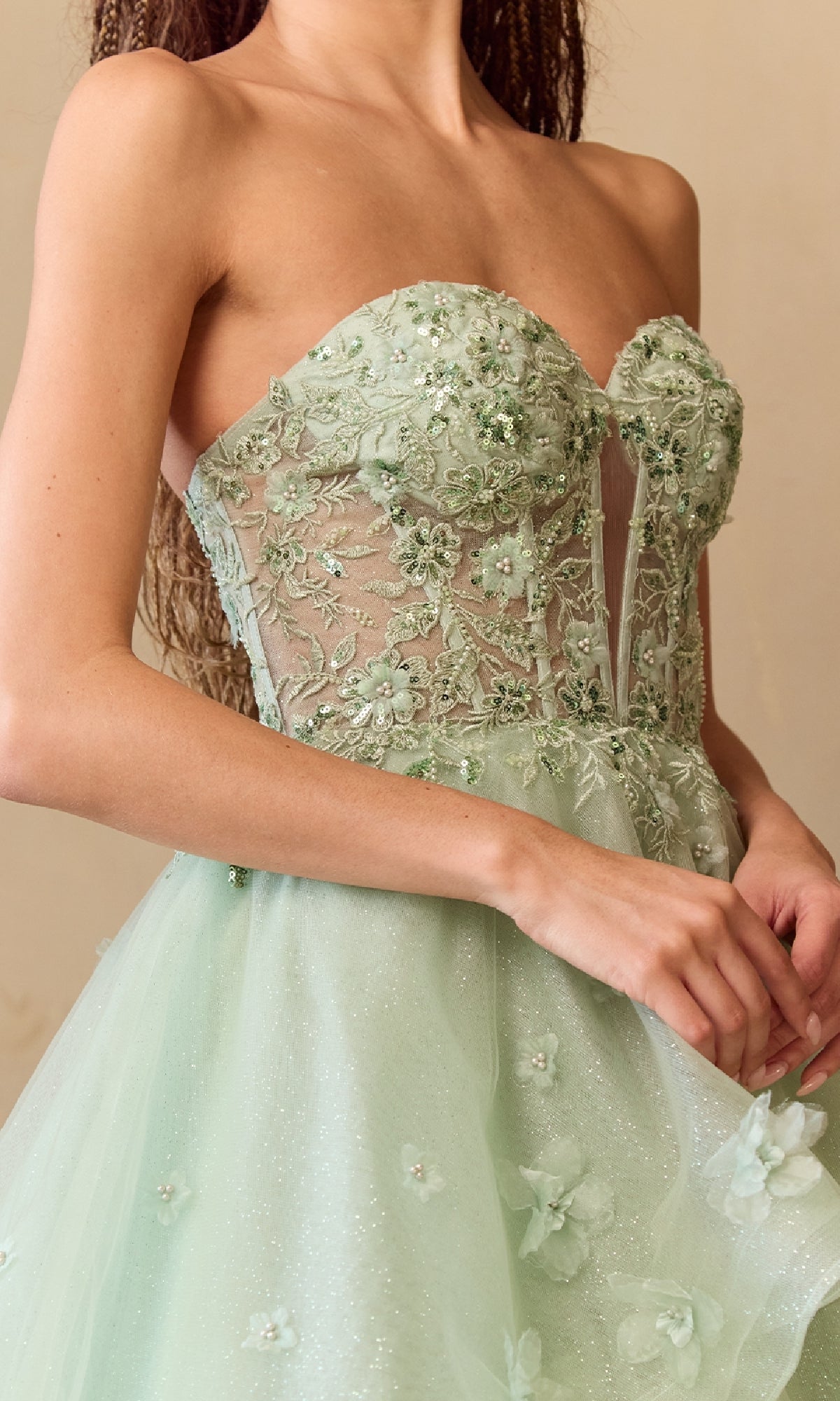 Light green strapless dress with floral lace details on a neutral background