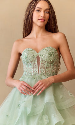 Woman wearing a light green strapless dress with floral details against a beige background