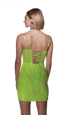 A person wearing the Alyce V-Neck Short Sequin-Print Hoco Dress 4901 in neon green, featuring spaghetti straps and lace-up back detailing, stands facing away from the camera against a white background.