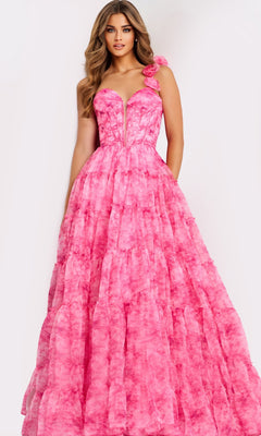 A woman stands against a plain light background wearing the Jovani 49074 long prom dress in print, featuring a floor-length skirt, fitted corset-style bodice, and floral detail on one shoulder.