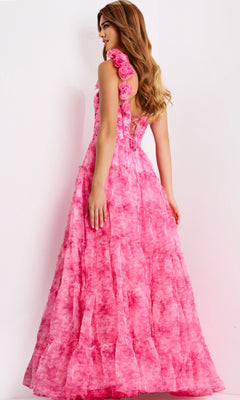 A woman wears the Jovani 49074 long prom dress, a sleeveless, floor-length pink gown with layered fabric, rose shoulder details, and a subtle corset bodice, standing against a plain light background.