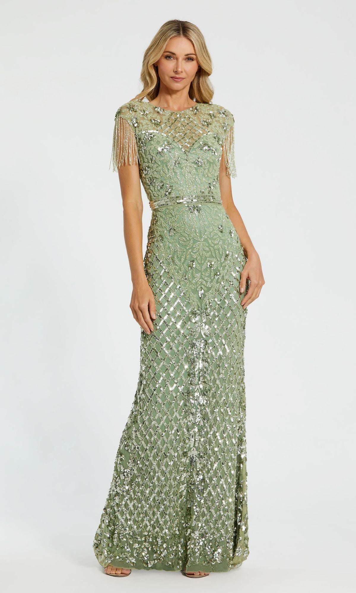 A woman stands against a plain white background, wearing the Cap-Sleeve Beaded Formal Gown: Mac Duggal 4908, a floor-length pale green dress adorned with sequins and short fringe sleeves for an elegant look.