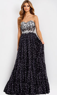 A woman models the Jovani 49086 long prom dress, showcasing a strapless sheer floral lace corset bodice and a full A-line polka dot skirt against a plain light background.