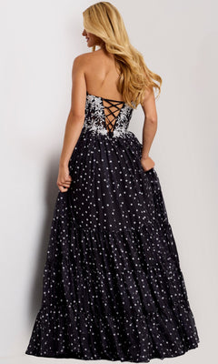 Woman wearing the Jovani 49086 long prom dress with a strapless floral lace corset bodice and A-line polka dot skirt, standing against a plain background.