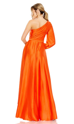 A woman models the Mac Duggal 49141 One-Sleeve High-Low Prom Dress in shiny orange, featuring a single long sleeve and one-shoulder design, standing and facing slightly away from the camera.