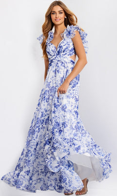 A woman in the Jovani 49143 Ruffled Long Print Prom Dress, featuring blue floral patterns, ruffled sleeves, and a flowing skirt, stands against a plain light background.