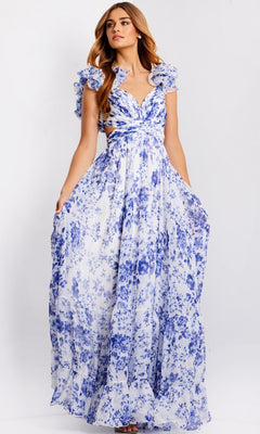 A woman models the Jovani 49143, a ruffled long print prom dress with blue floral patterns, standing against a plain background.