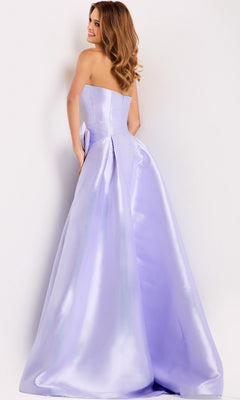 A woman in the Jovani 49196 Long Prom Dress, featuring a strapless satin bodice and A-line skirt, stands facing away and looks over her shoulder with a slight smile.