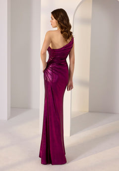 A woman wearing the Morilee 49230 long prom dress in shiny magenta stands with her back to the camera in a minimalist, light-filled setting.