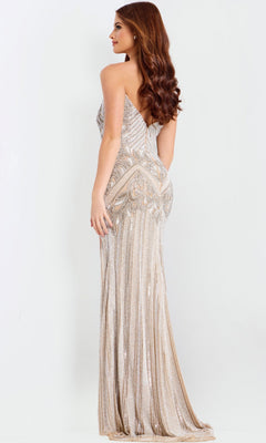 A woman models the Jovani 49248 long prom dress, standing sideways against a white background to highlight its shimmering silver and nude beaded embellishments.