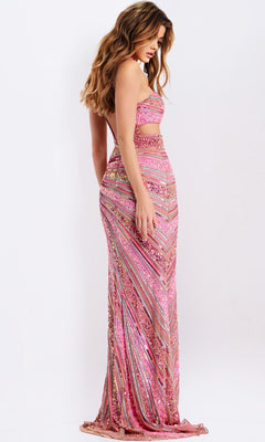 A woman stands sideways against a plain white background wearing the Jovani 49266, a long, strapless pink and gold prom dress with cutout details and a form-fitting silhouette.