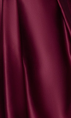 Close-up of smooth, burgundy satin fabric with a soft sheen, featured in the Plus Short Wine Hoco Dress: Blondie Nites 4927BNW—perfect for an elegant wine red party or plus-size homecoming look.