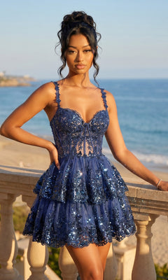 A woman wearing the Blondie Nites 4931BN Short Ruffled Hoco Dress in navy stands by a stone balcony with the beach and ocean in the background.
