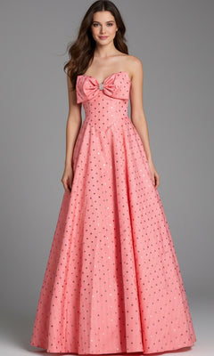 A woman wearing the Jovani 49340 long prom dress in salmon, a strapless ballgown with a large chest bow and small metallic polka dots.