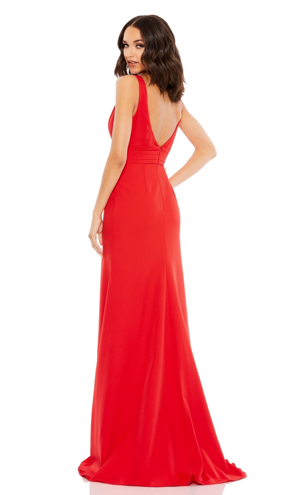 Woman wearing the Mac Duggal 49454 Shoulder-Bow Long Prom Dress, a floor-length, sleeveless red gown with a deep V-back, standing and looking over her shoulder.