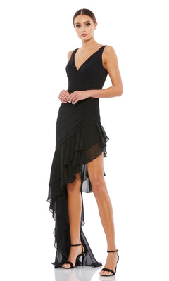 A woman in the Black High-Low Ruffled Homecoming Dress 49487 and black heels stands against a white background.
