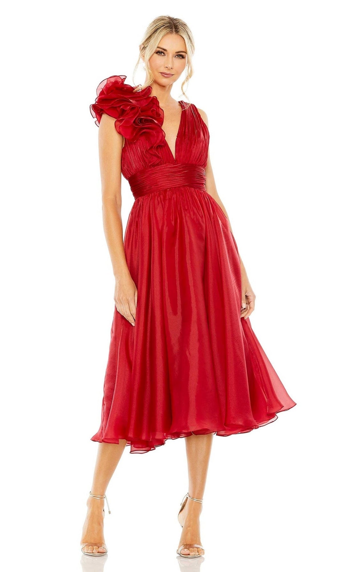 A woman wears the Short Ruched Wedding-Guest Dress: Mac Duggal 49494—red, knee-length, one-shoulder with ruffles—paired with silver heels against a white background, making a stunning choice for wedding guests.