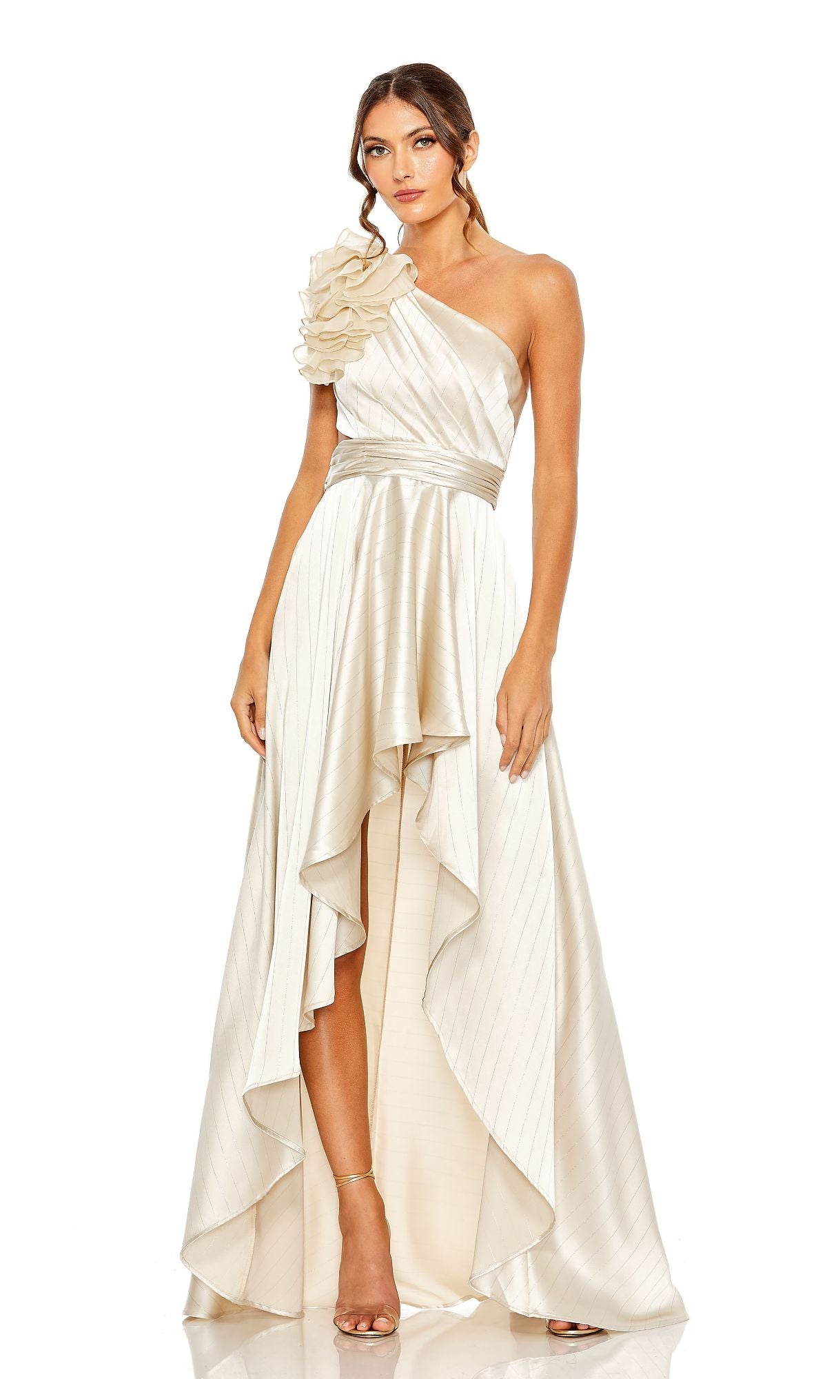 A woman wears the Mac Duggal 49523 cream-colored one-shoulder wedding guest dress with a ruffled shoulder and asymmetrical hem, posing against a white background—a perfect party dress choice.