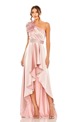 Woman in a light pink Mac Duggal 49523 one-shoulder wedding guest dress with ruffle strap and asymmetrical layered hem, paired with strappy high heels—a chic party-ready look.