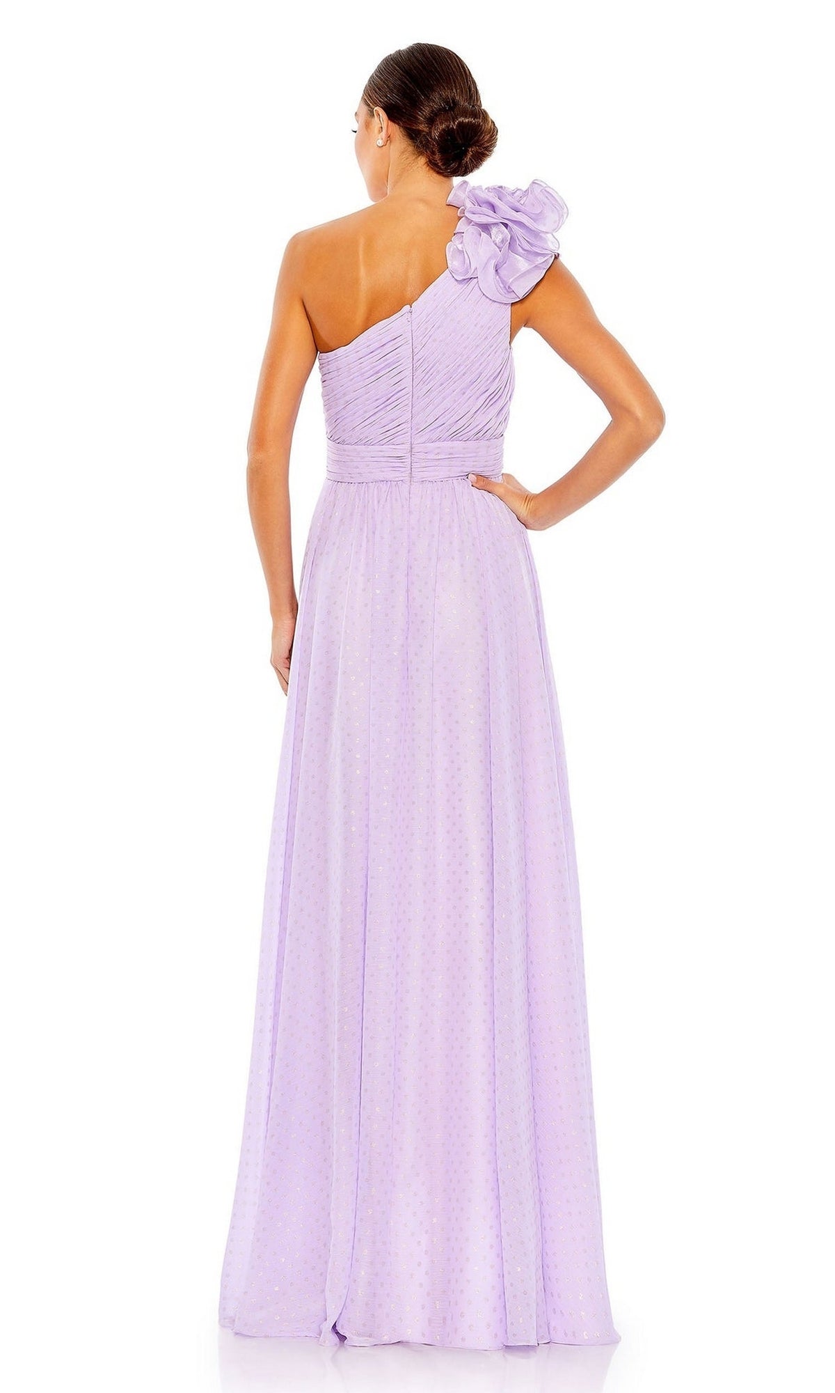 A woman faces away in the Mac Duggal 49536 one-shoulder long formal dress, showcasing its elegant pleated design and striking floral accent—an ideal choice for a stunning bridesmaid look.