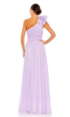 A woman faces away in the Mac Duggal 49536 one-shoulder long formal dress, showcasing its elegant pleated design and striking floral accent—an ideal choice for a stunning bridesmaid look.