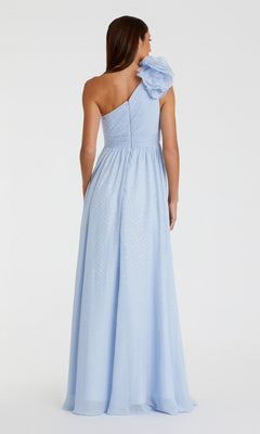 Woman facing away, wearing the Mac Duggal 49536—an elegant one-shoulder long formal dress featuring a dramatic ruffle on the shoulder and a subtle polka dot texture in light blue.