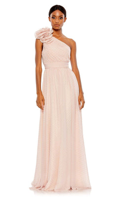 A woman wears the Mac Duggal 49536, a one-shoulder long formal dress in light pink with a floral accent and a textured, flowing floor-length skirt.