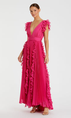 A woman models the Mac Duggal Ruffle-Sleeve Long Formal Dress 49539 in hot pink, featuring a deep V-neckline and pleated fabric, paired with open-toe heels against a plain white background.