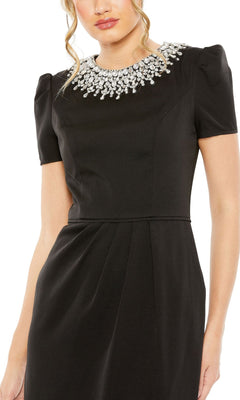 A woman models the Mac Duggal 49606 Short Sleeve Tea-Length Party Dress, featuring a fitted waist and jeweled neckline, against a plain background.