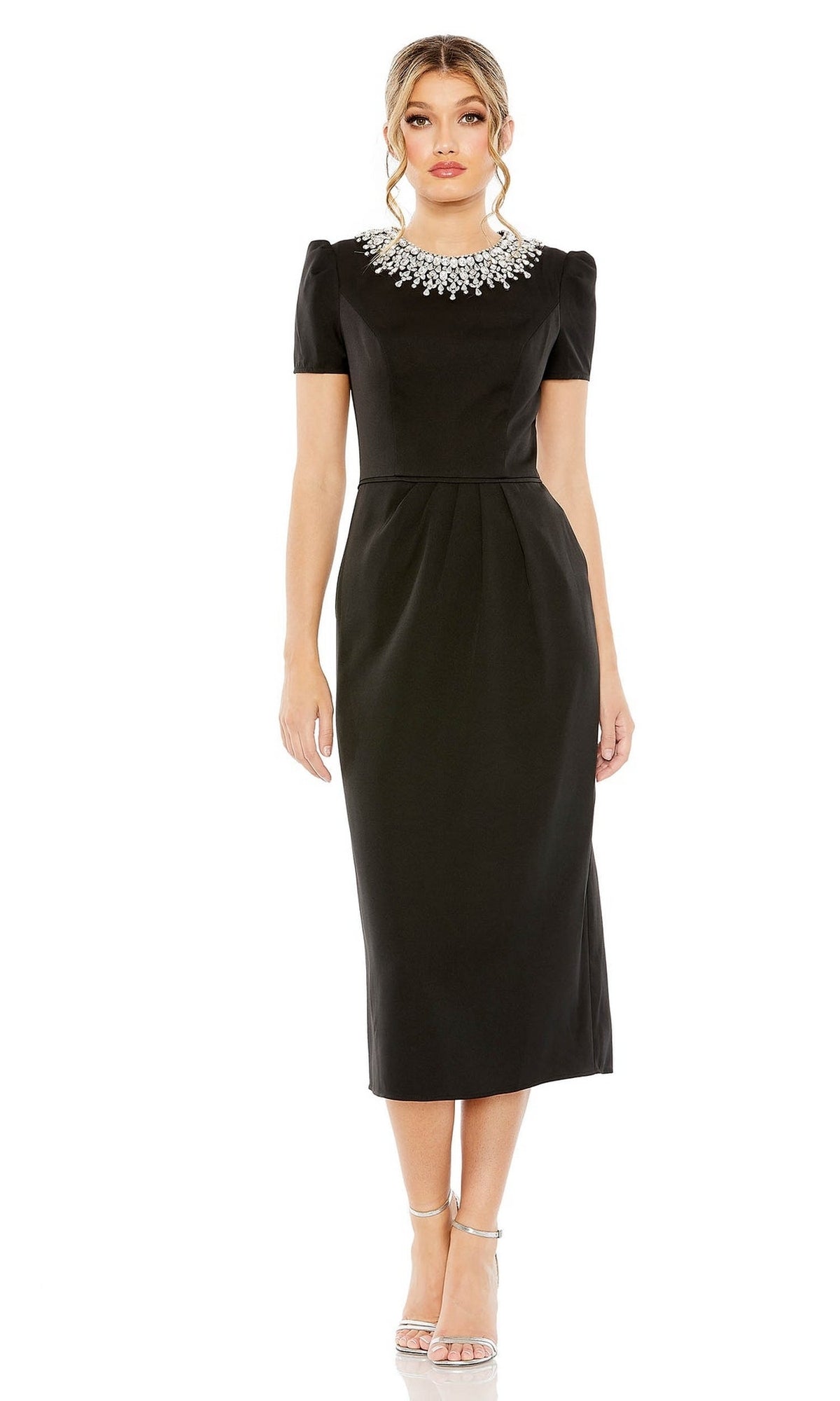 Woman wearing the Mac Duggal 49606 short sleeve tea-length party dress with a black beaded collar, paired with silver strappy heels, standing against a white background.