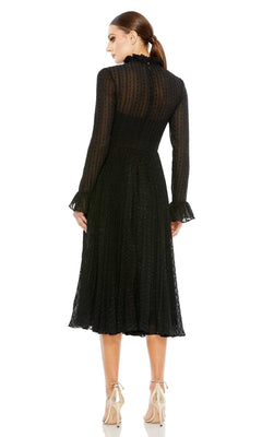 A woman stands with her back to the camera, her hair tied back, wearing the Mac Duggal Short Wedding Guest Dress 49627— a black long sleeve dress featuring sheer dotted fabric and a high neck, styled with nude high-heeled shoes.