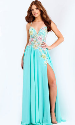 A woman stands against a plain background wearing the Jovani 49633 long prom dress in light blue, featuring floral appliques, a sheer corset bodice, and a high slit on one side.