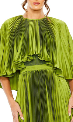 A woman wears the Caped Tea-Length Party Dress: Mac Duggal 49638 in shiny pleated green, featuring wide sleeves and a gathered waist, shown from mid-face to mid-thigh.