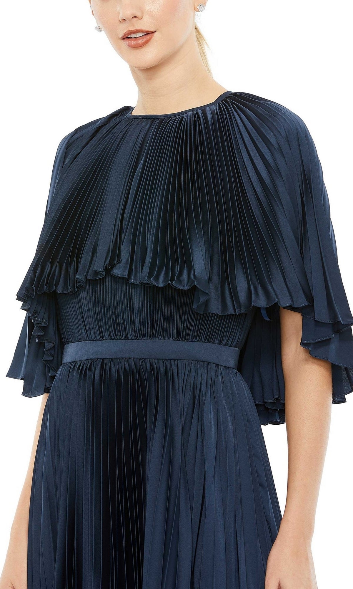 A woman wearing the Mac Duggal 49638 Caped Tea-Length Party Dress—a dark blue, short-sleeved design with pleats and a belted waist—shown from shoulders to mid-thigh for a chic party-ready look.