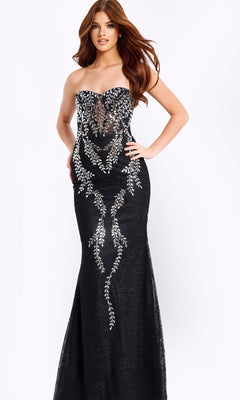 A woman stands against a plain white background in the Jovani 49658 long prom dress, a strapless black and silver gown with crystal-beaded embellishments.