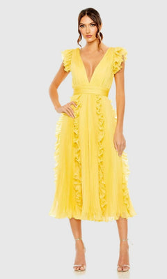 A woman wearing the Short Wedding Guest Dress 49675 by Mac Duggal, featuring yellow ruffle cap sleeves and a deep V-neckline, stands in heels against a light gray background.