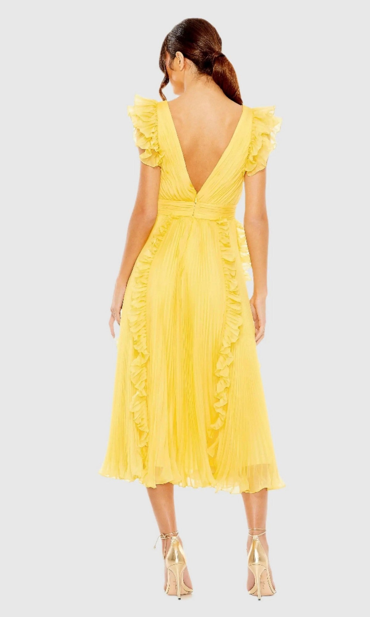 A woman poses against a plain background in the Short Wedding Guest Dress 49675 by Mac Duggal, featuring yellow pleats, ruffle cap sleeves, a deep V-back, midi length, and gold high-heeled sandals.