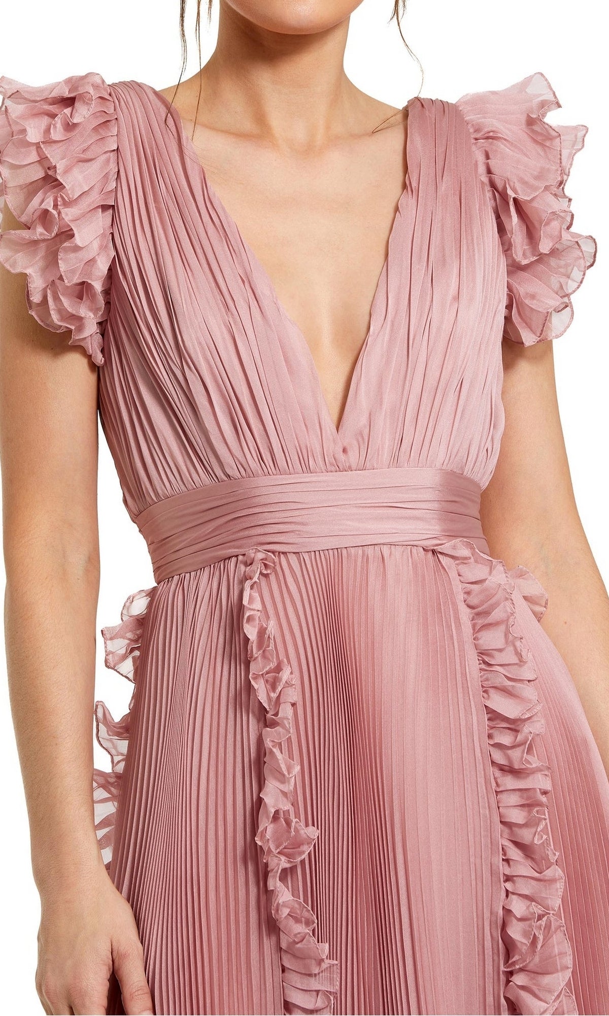 A woman wears the Mac Duggal Short Wedding Guest Dress 49675, a rose pink chiffon midi with pleated fabric, ruffle cap sleeves, deep V-neckline, and fitted waistband—stylish for parties or as a chic wedding guest look.