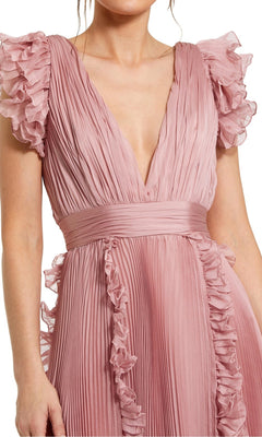 A woman wears the Mac Duggal Short Wedding Guest Dress 49675, a rose pink chiffon midi with pleated fabric, ruffle cap sleeves, deep V-neckline, and fitted waistband—stylish for parties or as a chic wedding guest look.