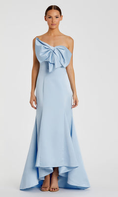 A woman wears the Mac Duggal 49701 Strapless Mermaid Formal Dress, featuring a floor-length silhouette and paired with nude heels.