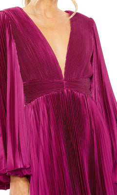 A person is wearing the Mac Duggal 49717 Berry Red Wedding Guest Dress, which features long sleeves, a pleated midi skirt, and a deep V-neckline.